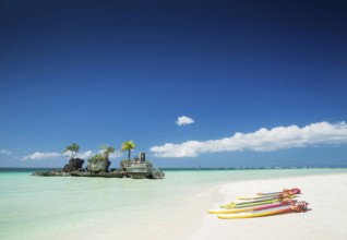 Tropical beach christian shrine and tourist canoes on boracay island philippines