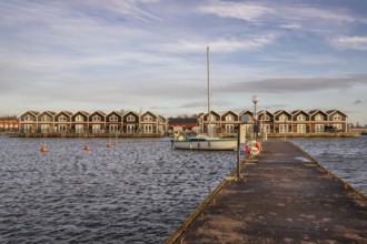 Harbour by the lake, landscape shot in autumn. Holiday village and harbour by the water in Sunnana