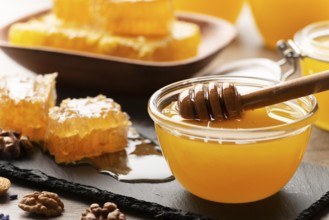 Honeycomb on slate tray with honey and nuts on kitchen table, food photography, food photography