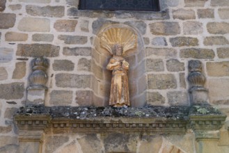 Old religious statue in French wall