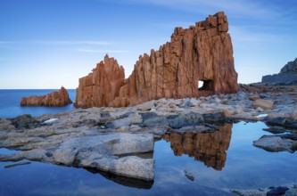 A view of the red rocks of Arbatax with reflections in tidal pools in the foreground