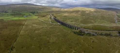 Ribblehead Viaduct, railway viaduct in the Yorkshire Dales, behind Whernside mountain, drone shot,