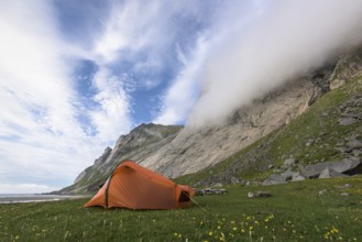 Tent at the foot of a rock face, Buneset, Moskenesöya, Lofoten, Nordland, Norway, July 2015, Europe