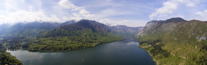 Aerial panorama of Bohinjsko jezero lake between mountains in Slovenia at spring
