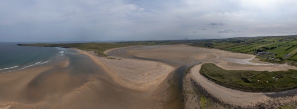 A panorama drone landscape view of the beautiful golden sand beach at Lacken Strand on the coast of