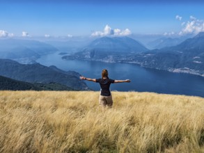 Woman walking in a prairie on Lake Como alps