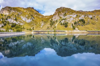 Mountain Lake Lago di Fedadia, Dolomites. Glacial lake with clear cold water. Cool autumn day at