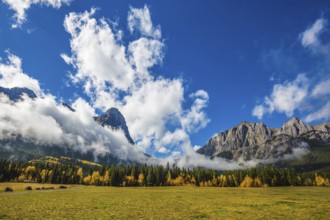Concept of hiking. Auroral sunny day in Canmore. The famous Three Sisters mountains in the Canadian