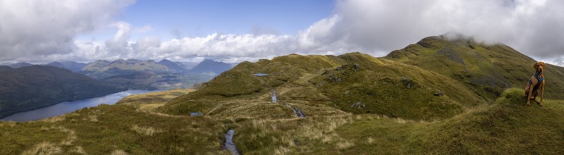 Panorama on the summit path to Ben Lomond with mountain lake and male Magyar Vizsla, Loch Lomond