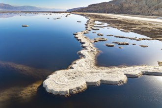 Evaporated salt patterns on the surface of the blue water. The photo was taken from a drone. Magic
