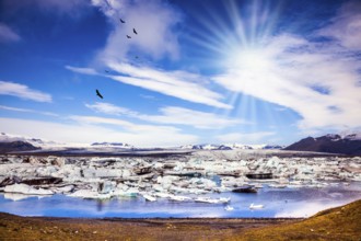 The concept of extreme tourism. Ice floes are reflected in the water surface lake. Cool northern