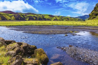 On bottom of canyon many streams flow. Canyon Pakgil in Iceland. Picturesque basalt hills overgrown