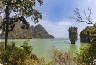 A colorful picture of the beautiful landscape of the James Bond Island and its iconic islet