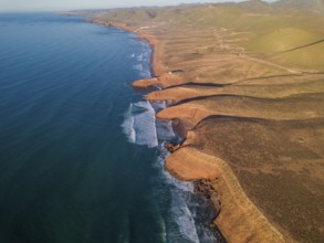 Aerial view on Legzira beach with arched rocks on the Atlantic coast at sunset in Morocco