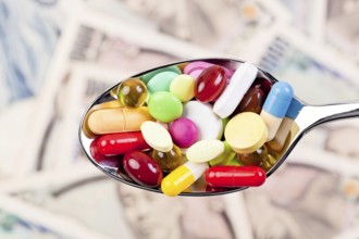 Tablets and Japanese yen currency, symbol of healthcare costs