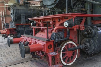 Lateral railway component of a steam locomotive with red and black components, Bochum, North
