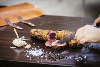 Serving carving roast pork meat roll meal in rustic style with seasonings