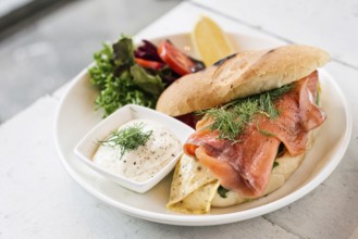 Scandinavian healthy fresh smoked salmon sandwich with egg and sour cream set meal