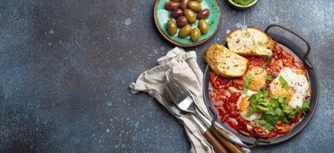 Middle Eastern and Maghrebi healthy dish Shakshouka made of eggs and tomato sauce served in pan