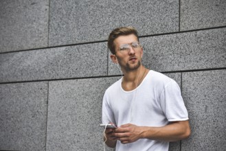 People, technology, travel and tourism, man with earphones, smartphone on city street and listening