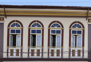 Close-up of a colonial house facade with windows and doors in historical town São Luíz do
