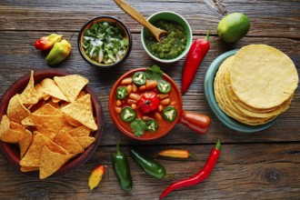 Frijoles charros mexican beans with chili pepper sides and tortillas