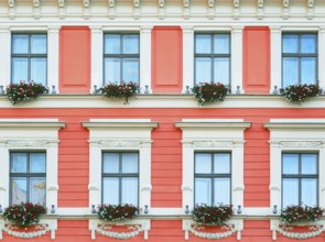 The Facade Of The Building With Flowers