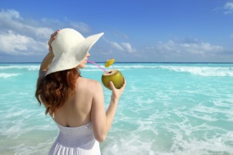 Beach hat profile girl drinking acoconut fresh cocktail in tropical Caribbean sea
