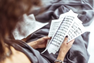 Close up music notes in women's hands