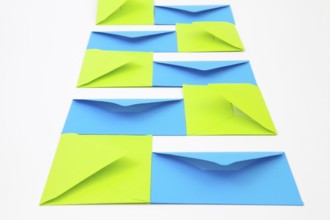 Composition with green and blue envelopes on the white table