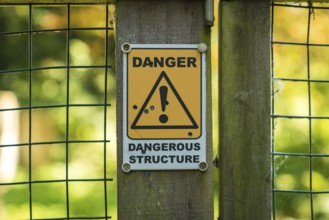 Sign: Dangerous structure, seen in Oare near Faversham, Kent, England, UK