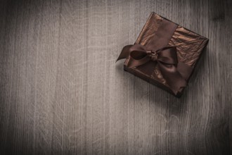 Present boxed in glittery crumpled paper with bow celebration concept