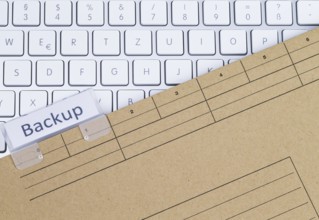 The photo shows a white keyboard with a briefcase