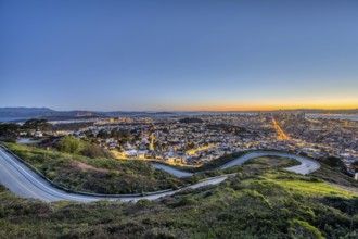 San Francisco with the Golden Gate Bridge in front of sunrise