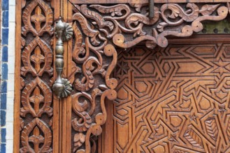 Rich decorated door in an Arab palace in Marrakech, Morocco, Africa