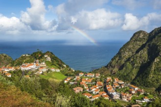 View from the Miradouro de Pastel over the small coastal village of Boaventura with its orange