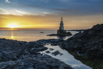 The Athopol Lighthouse on the Black Sea coast of Bulgaria with tidal pools in the foreground at