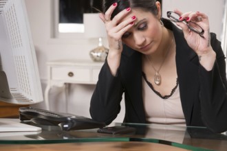 Woman at computer desks looks frustrated