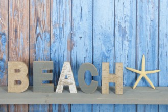 Blue wooden background with beach text