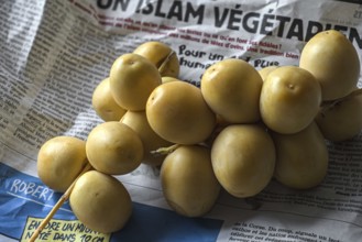 Fresh dates from French vegetables market on newspaper