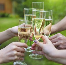 Celebration. People holding glasses of champagne making a toast outdoors