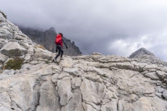 Hiker on the crest of Puig de Ses Vinyes, 1105 meters, sierra de tramuntana, Escorca, Majorca,