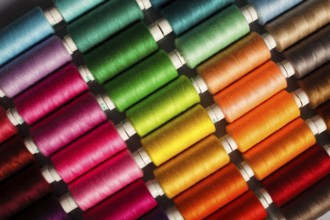 Sewing threads multicolored background closeup