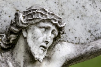 Crucifixion of Jesus on a gravestone in the Barbarafriedhof cemetery in Linz, Austria, Suffering