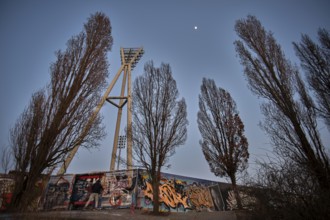 Germany, Berlin, 08.03.2025, Graffiti wall, Mauerpark, floodlight mast of the Cantian Stadium,