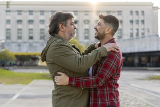 Two married men who are in love are embracing each other
