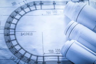 Rolled up construction plans on blueprint top view
