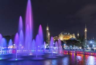 A picture of the Hagia Sophia and the colorful Sultan Ahmet Park Fountain at night
