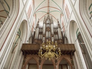 Interior view of a church with a large organ and a chandelier, Gothic architecture, Schwerin,