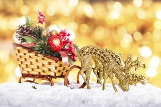 Christmas sleigh with decor and reindeers in the snow